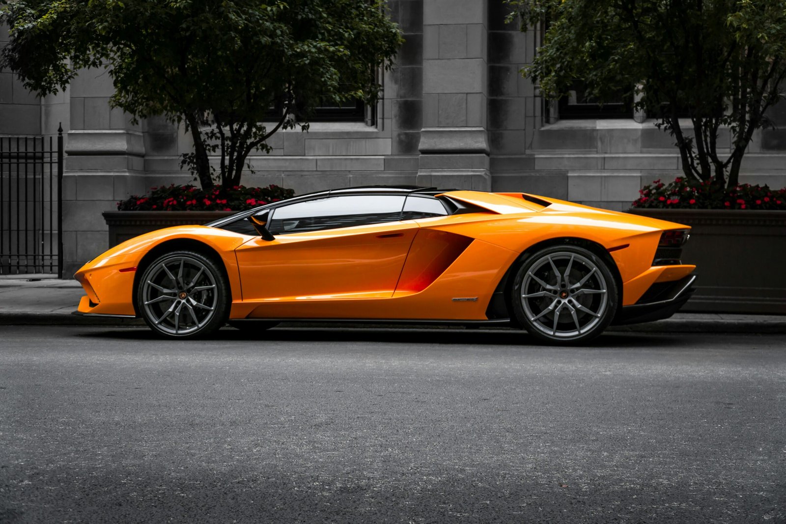 orange sports car on roadway